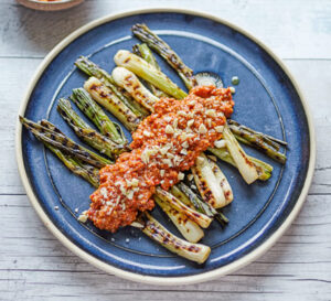 charred spring onions with romesco